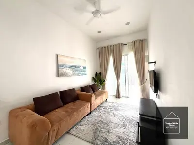 a living room with a couch and a television at Zafirah Ipoh Homestay Musllim Only in Ipoh
