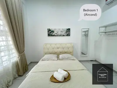 a bedroom with a bed with a hat on it at Zafirah Ipoh Homestay Musllim Only in Ipoh