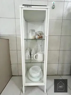 a white cabinet with a stack of plates and cups at Zafirah Ipoh Homestay Musllim Only in Ipoh