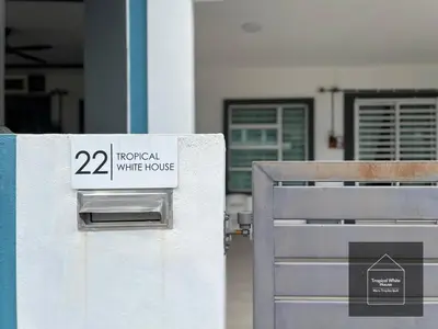 a white house sign on the side of a building at Zafirah Ipoh Homestay Musllim Only in Ipoh