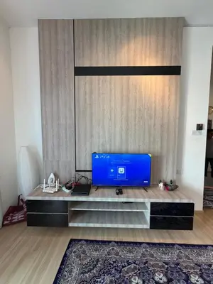 a living room with a blue tv on a table at AYAAN GAMING CLUB House with PS4 & Table Tennis at Cameron Highland in Tanah Rata