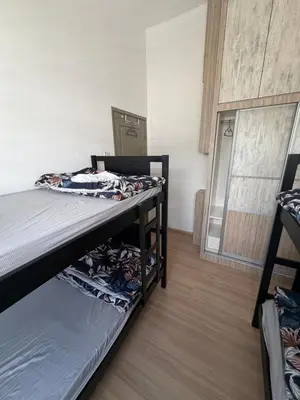 two bunk beds in a room with a mirror at AYAAN GAMING CLUB House with PS4 & Table Tennis at Cameron Highland in Tanah Rata