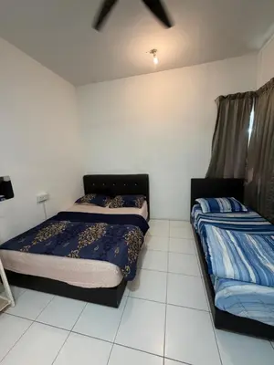 two beds in a room with white tiles at AYAAN ELITE HOME at Quintet Apartment with free parking & Ps4 Gaming and Netflix in Tanah Rata
