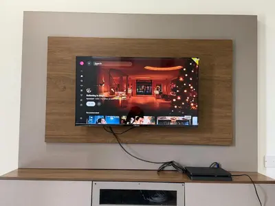 a flat screen tv hanging on a wall at AYAAN ELITE HOME at Quintet Apartment with free parking & Ps4 Gaming and Netflix in Tanah Rata
