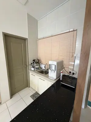 a small kitchen with a sink and a microwave at AYAAN ELITE HOME at Quintet Apartment with free parking & Ps4 Gaming and Netflix in Tanah Rata