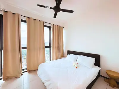 a bedroom with a white bed with a ceiling fan at Urban Seaview, City view, New 3BR 6pax, Jelutong in George Town