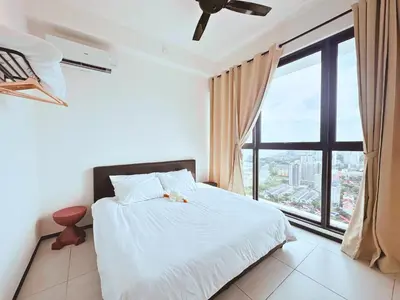 a bedroom with a bed and a large window at Urban Seaview, City view, New 3BR 6pax, Jelutong in George Town