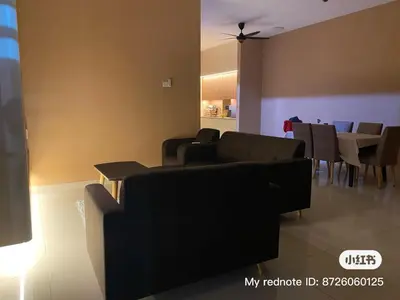 a living room with couches and a dining room at HOMESTAY Mu in Simpang Ampat