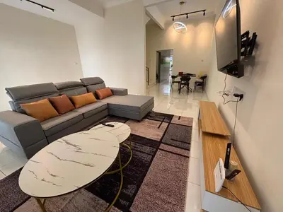 a living room with a couch and a table at pangkor 71 homestay in Pasir Bogak