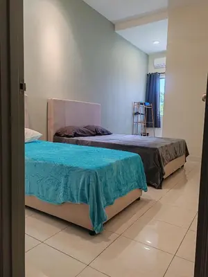 two beds sitting next to each other in a room at pangkor 71 homestay in Pasir Bogak
