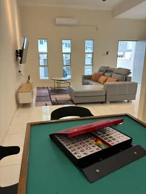a living room with a pool table with bats on it at pangkor 71 homestay in Pasir Bogak