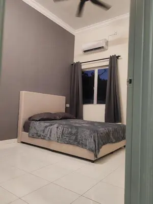 a bed in a bedroom with a window and a ceiling fan at pangkor 71 homestay in Pasir Bogak