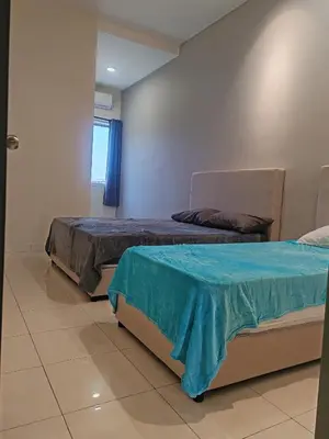 two beds sitting next to each other in a room at pangkor 71 homestay in Pasir Bogak