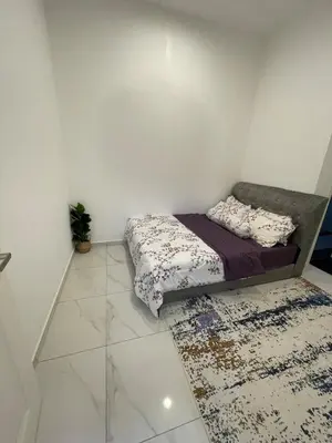 a small bedroom with a bed and a rug at Nadine Homestay in Sungai Petani