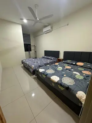 a bedroom with two beds and a ceiling fan at 96 HomeStay Sungai Besar in Sungai Besar