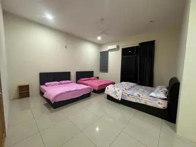 two beds in a room with pink sheets at 96 HomeStay Sungai Besar in Sungai Besar