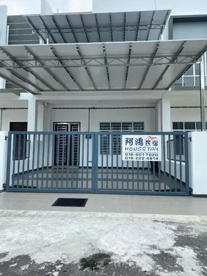 a gate with a sign in front of a building at HongStay SUNGAI BESAR in Sungai Besar
