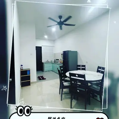 a kitchen with a table and chairs and a ceiling fan at HongStay SUNGAI BESAR in Sungai Besar