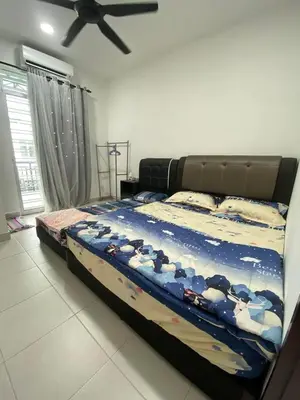 a bedroom with a large bed with cows on it at HongStay SUNGAI BESAR in Sungai Besar