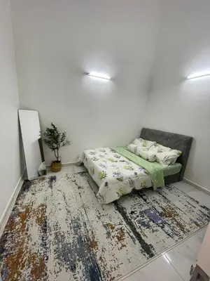 a bedroom with a bed and a rug on the floor at Nadine Homestay in Sungai Petani
