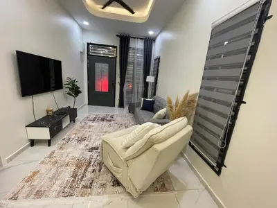 a living room with a couch and a tv at Nadine Homestay in Sungai Petani