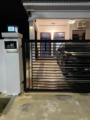 a front door of a house with a gate at Nadine Homestay in Sungai Petani