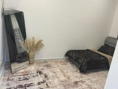 a bedroom with a bed and a vase on the floor at Nadine Homestay in Sungai Petani