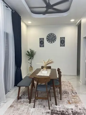 a dining room with a table and chairs and a ceiling at Nadine Homestay in Sungai Petani