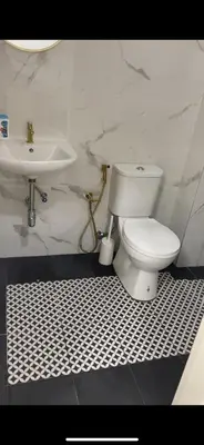a bathroom with a white toilet and a sink at Nadine Homestay in Sungai Petani