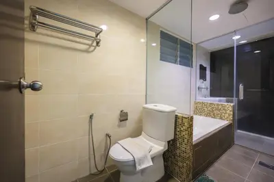 a bathroom with a toilet and a sink and a shower at Marina Island Lumut 3 Bedroom Holiday Apartment in Lumut