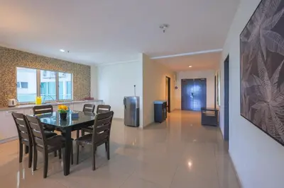 a dining room and kitchen with a table and chairs at Marina Island Lumut 3 Bedroom Holiday Apartment in Lumut