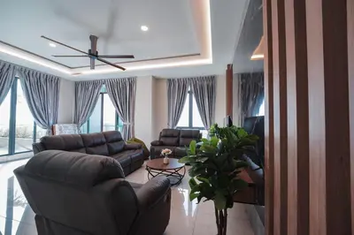 a living room with couches and a ceiling fan at 22 Penthouse by BRB, Airport View & 18 Pax in Bayan Lepas