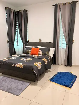 a bedroom with a bed with orange and blue pillows at KAYA HOMESTAY SRI IORa 2 in Sungai Petani
