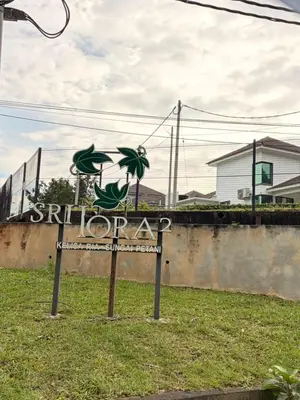 a sign for ahibagency in the grass next to a building at KAYA HOMESTAY SRI IORa 2 in Sungai Petani