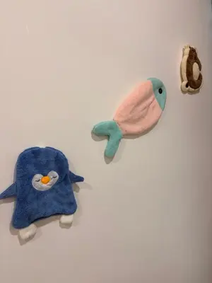 a group of stuffed animals on a white wall at KAYA HOMESTAY SRI IORa 2 in Sungai Petani