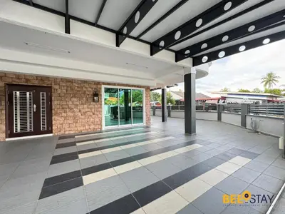 an outdoor patio with awning and a building at Taiping City Centre Landed Corner Lot for 12 Pax in Taiping