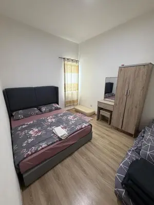 a bedroom with a bed and a desk in it at AYAAN ATRIUM Homestay with PS4 GAMING and Snookers in Tanah Rata