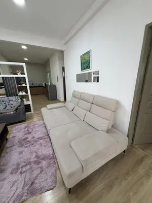 a white couch sitting in a living room at AYAAN ATRIUM Homestay with PS4 GAMING and Snookers in Tanah Rata