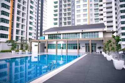 a swimming pool in a building with tall buildings at KoopJiha Homestay Meru Ipoh in Ipoh