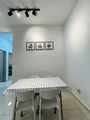 a white dining room with a table and chairs at KoopJiha Homestay Meru Ipoh in Ipoh