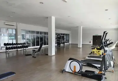 a gym with treadmills and machines in a room at KoopJiha Homestay Meru Ipoh in Ipoh