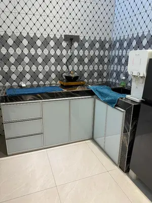 a kitchen with a counter with a blue tiled wall at New PRMO !!! Ipoh Staycation Homefeel 50