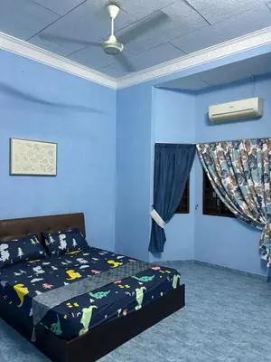 a blue bedroom with a bed and a blue wall at Homestay Laman Kasih Mama in Seri Manjung