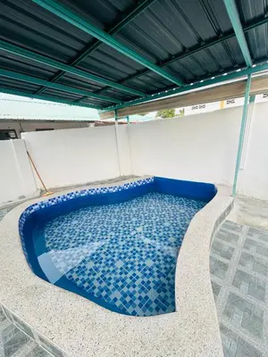 a swimming pool on the roof of a building at Homestay Laman Kasih Mama in Seri Manjung