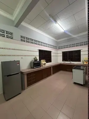 a large kitchen with a refrigerator and a stove at Homestay Laman Kasih Mama in Seri Manjung