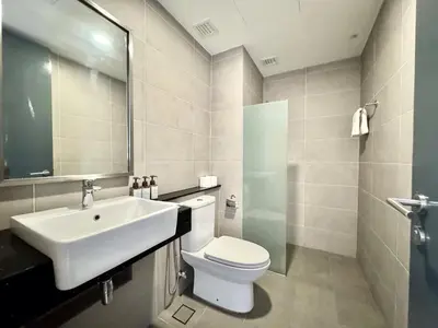 a white bathroom with a sink and a toilet at French Vintage Luxury 2BR Suites at Georgetown in George Town