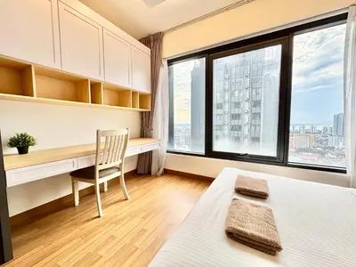 a bedroom with a desk and a bed and a window at French Vintage Luxury 2BR Suites at Georgetown in George Town