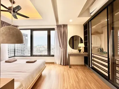 a bedroom with a bed and a large window at French Vintage Luxury 2BR Suites at Georgetown in George Town