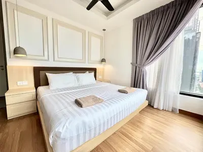 a bedroom with a bed with white sheets and a window at French Vintage Luxury 2BR Suites at Georgetown in George Town