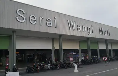 a group of motorcycles parked in front of a store at Sakeena Homestay in Padang Serai